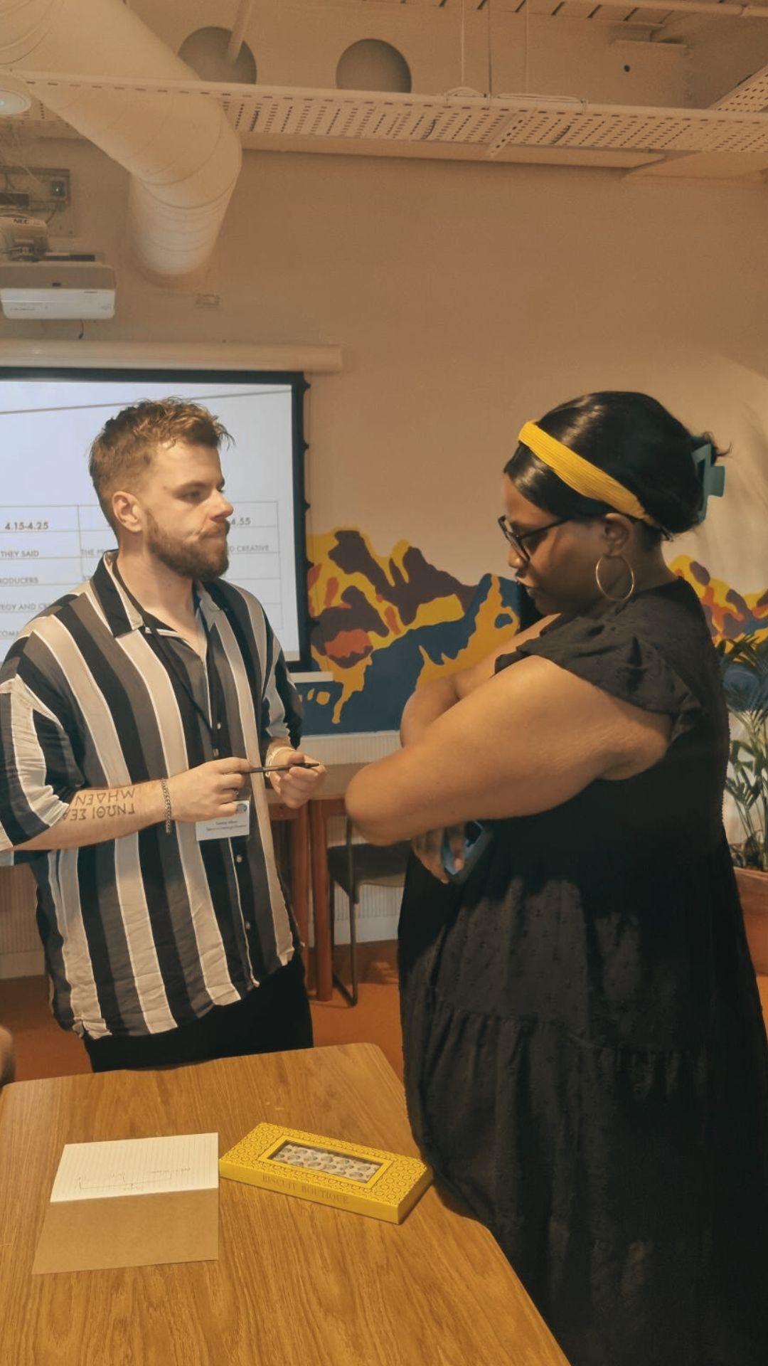 Two people in discussion at Brixton Finishing School
