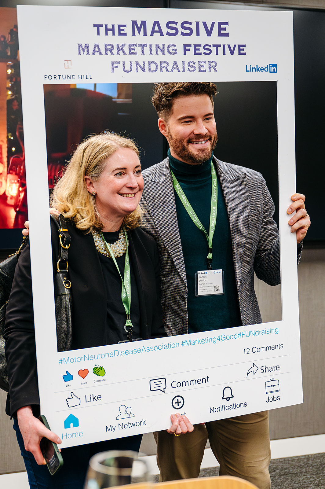 Two people holding up an instagram frame