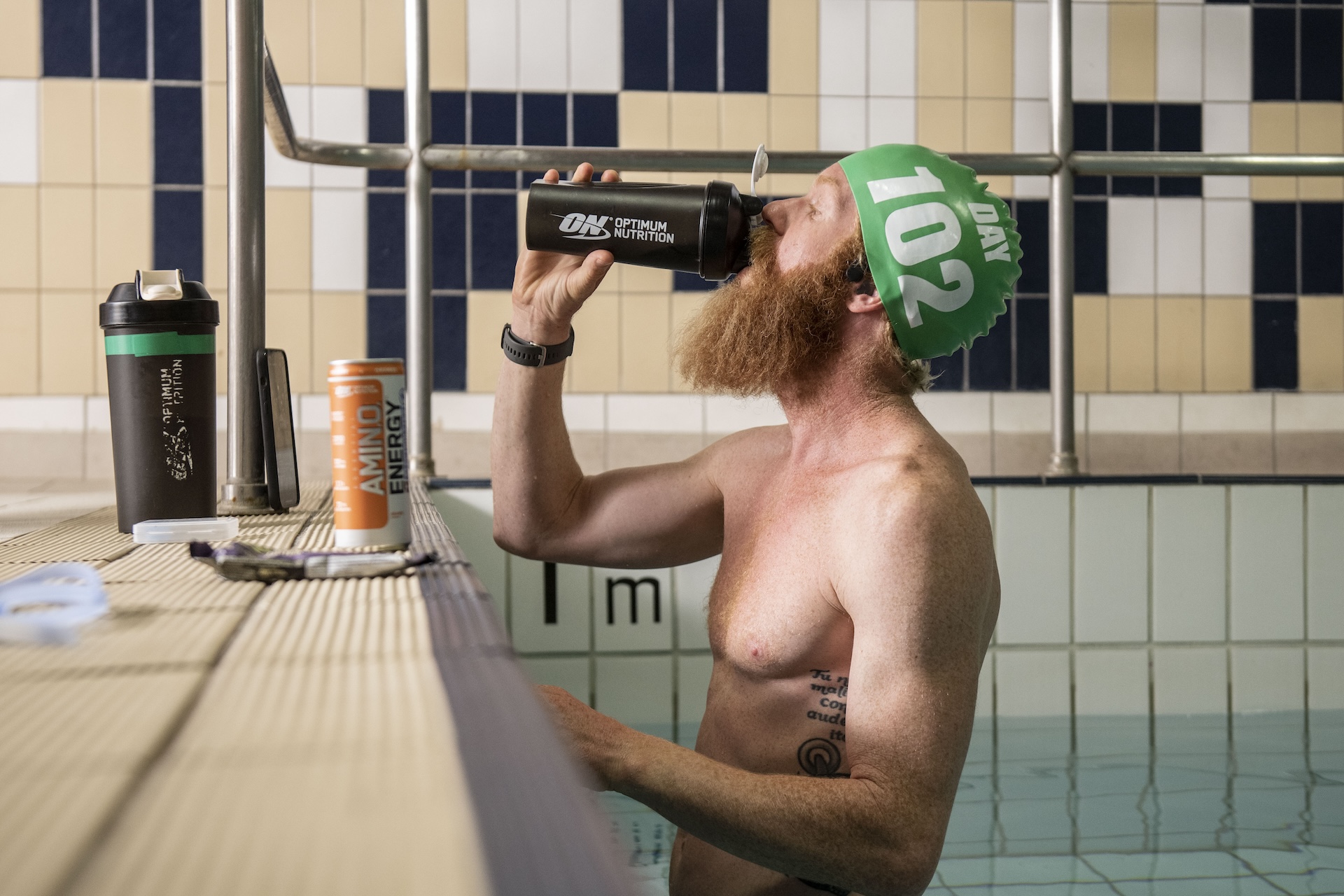 Sean in a swimming pool drinking