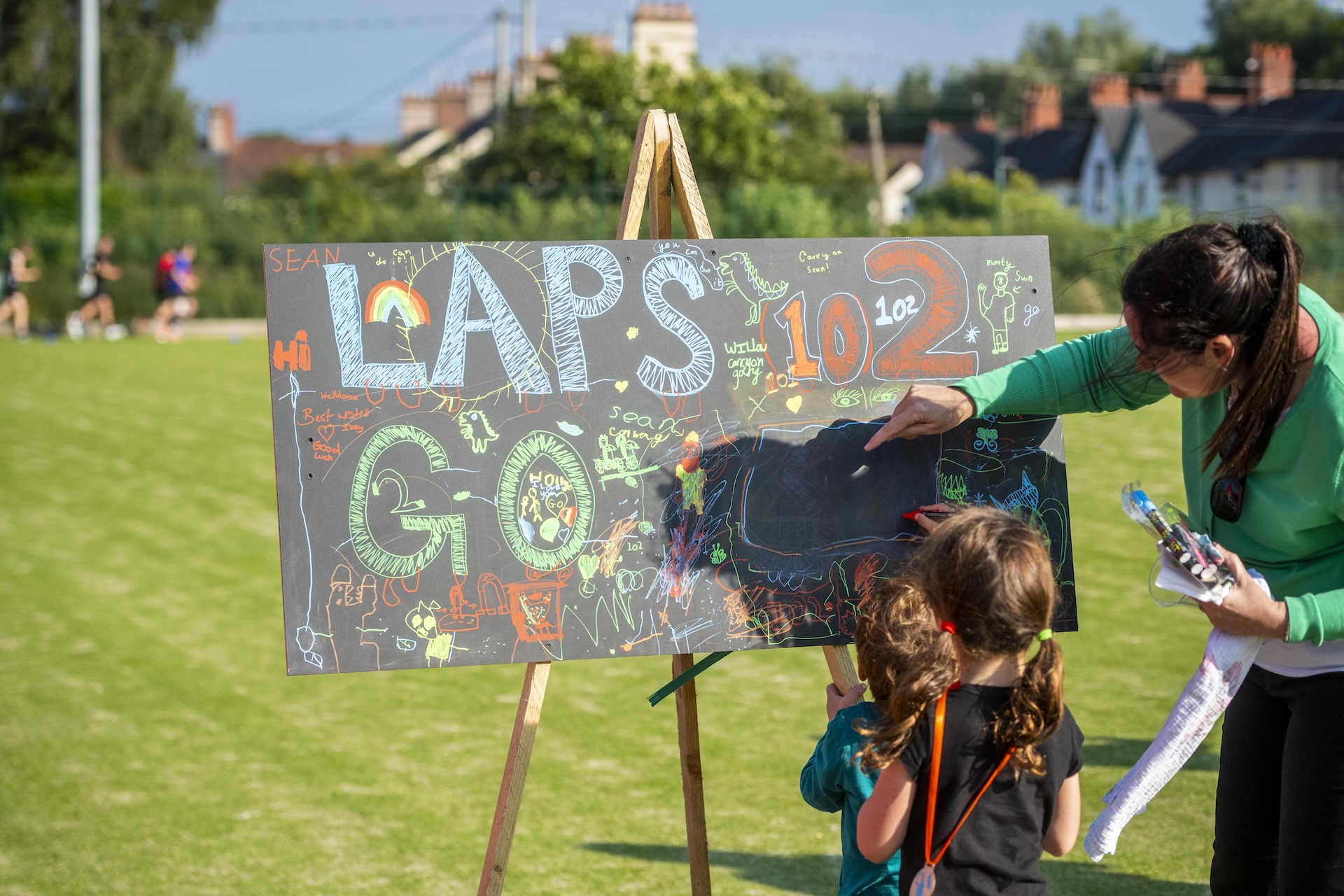 A child writes on a sign