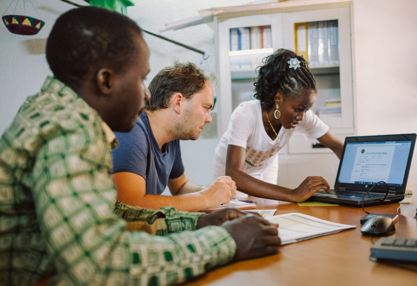 People staring at a laptop